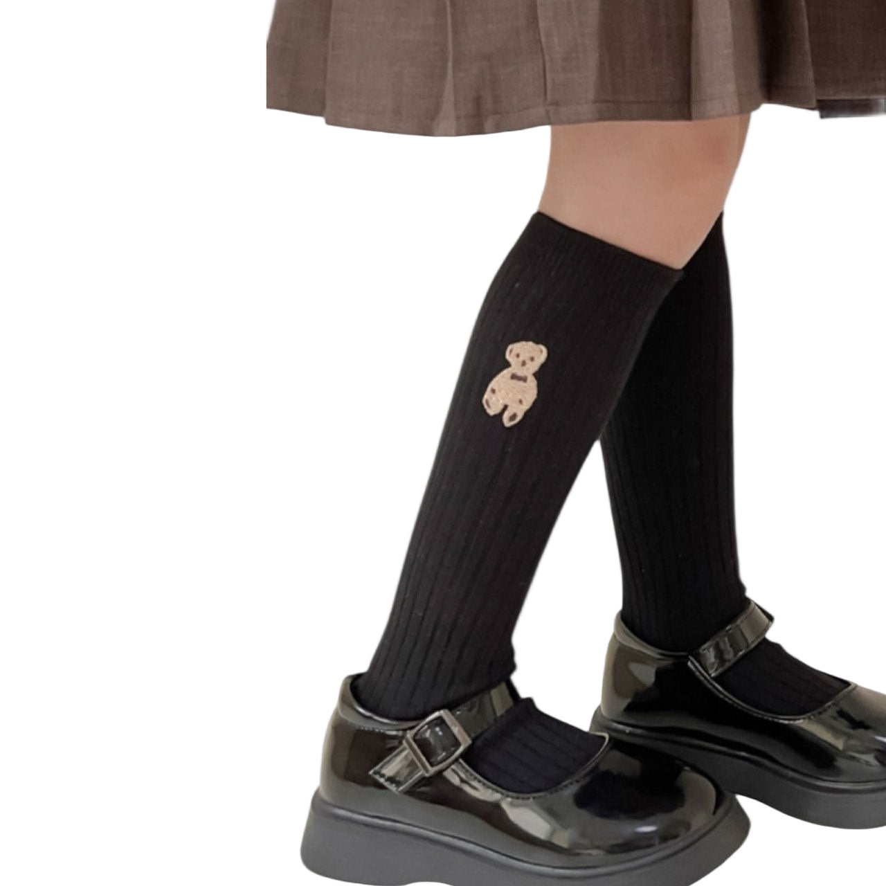 Black knee-high socks with a teddy bear design worn by a person in a school uniform.