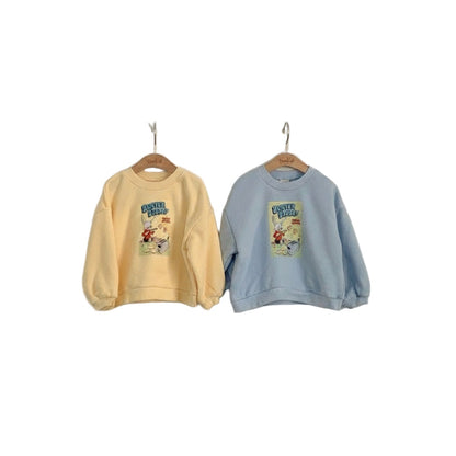 Two sweatshirts, one yellow and one blue, hanging on a plain wall.