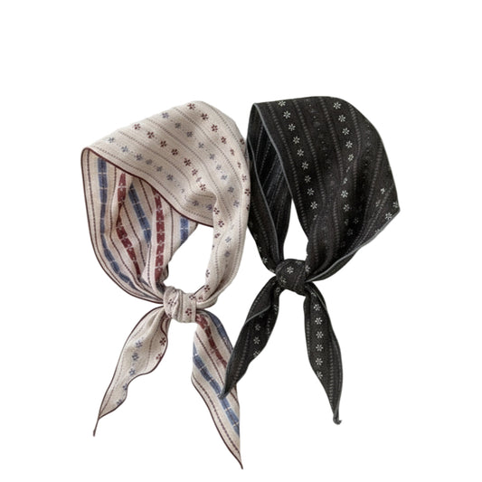 Two patterned headbands, one pink and one black with white patterns, on a light beige background with 'Dudie' branding.