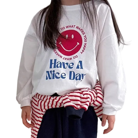 Two people wearing 'Have a Nice Day' sweatshirts with smiley face designs, standing side by side on a light-colored floor.